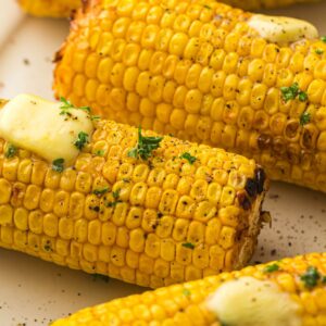 Corn on the cob on parchment paper.