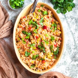 Pigeon Peas and Rice in an oval platter sprinkled with green onions.