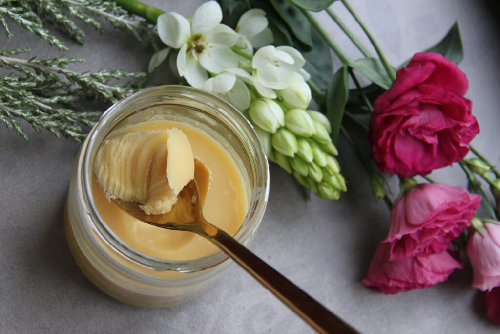 Ghee in a glass jar surrounded by flours.